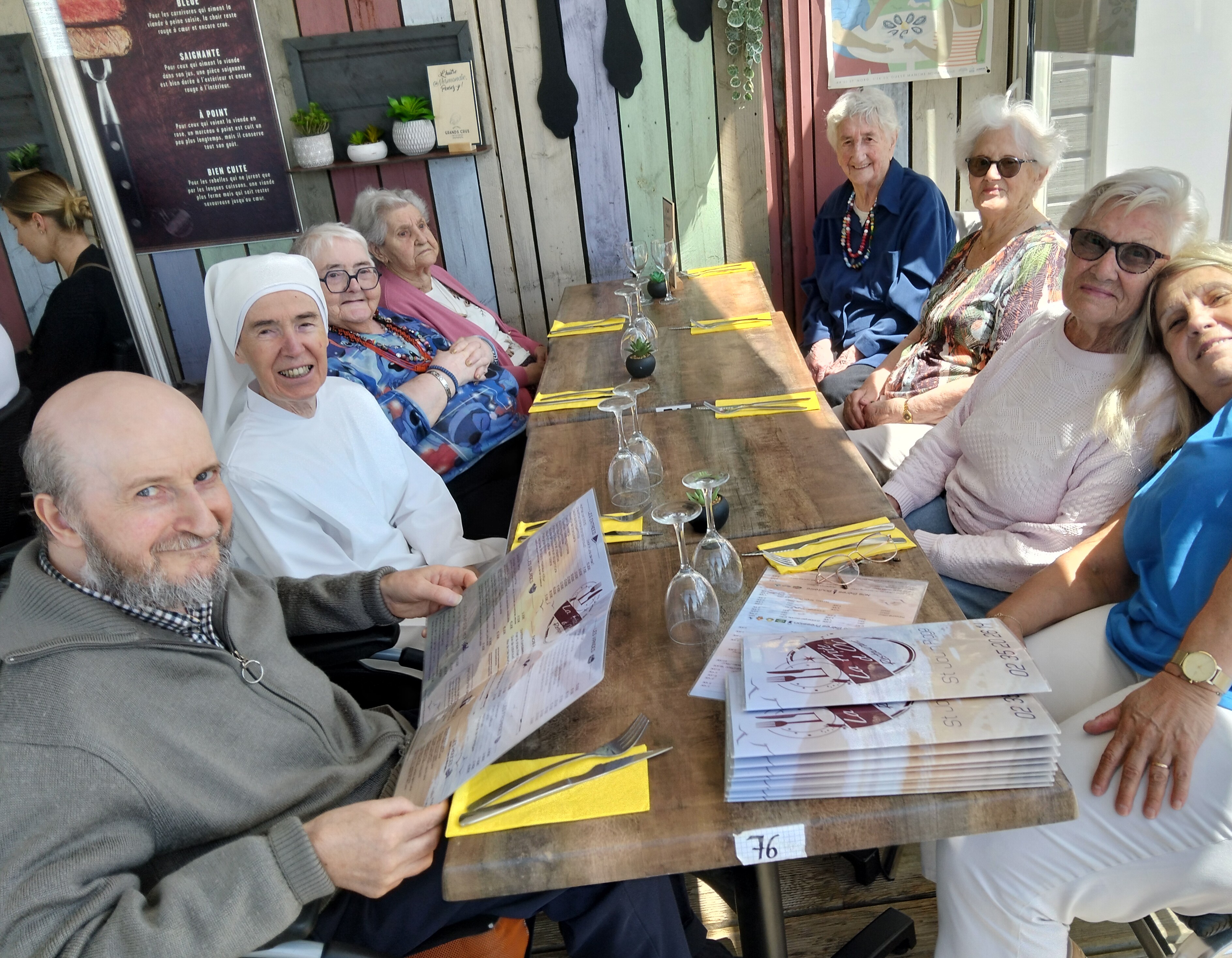 Personnes âgées au restaurant avec un moule frite face à la mer
